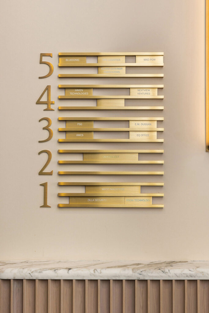 a building's company directory signage made of brass 