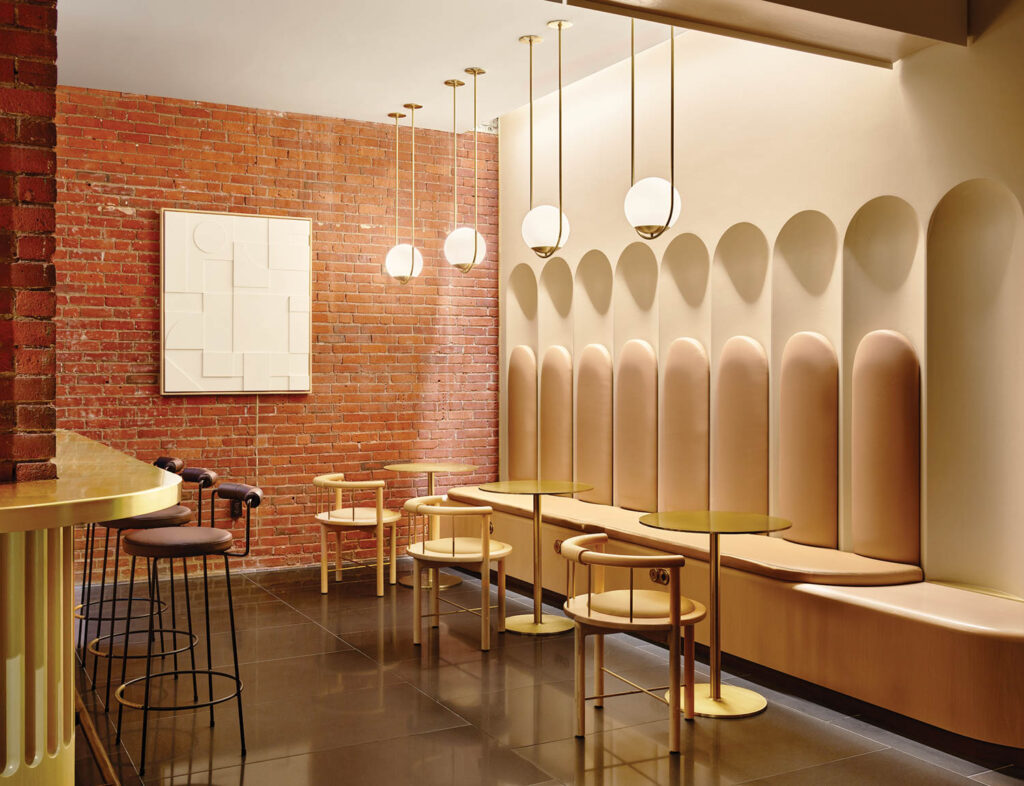 an events space with exposed brick and upholstered bench seating