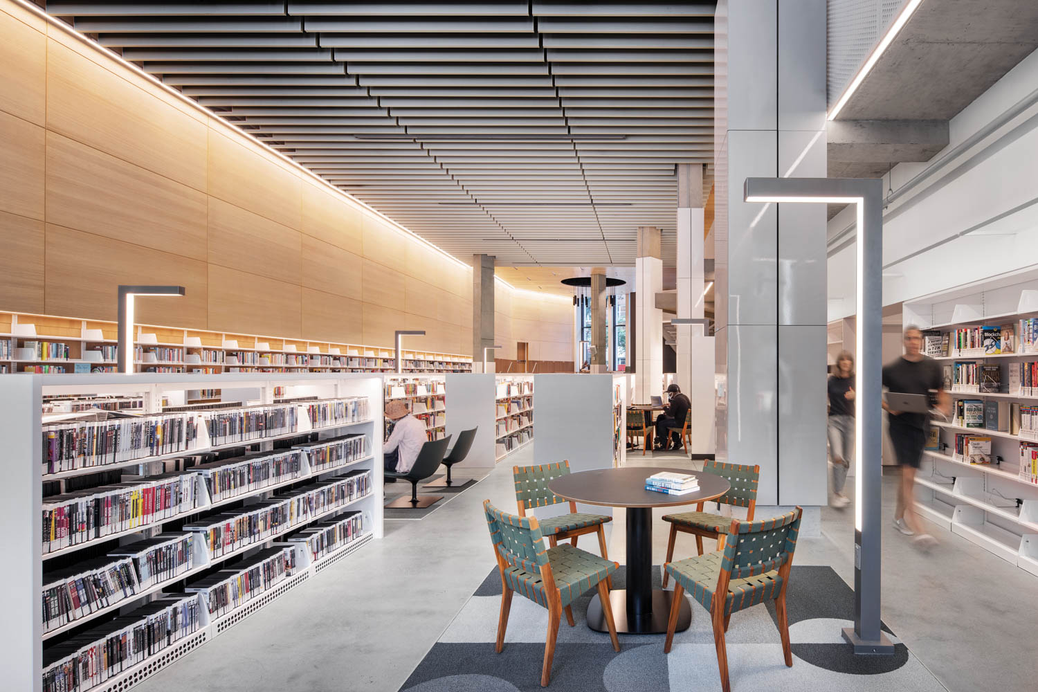 LED light fixtures cast a glow upon rows of books in the Brooklyn Heights Library