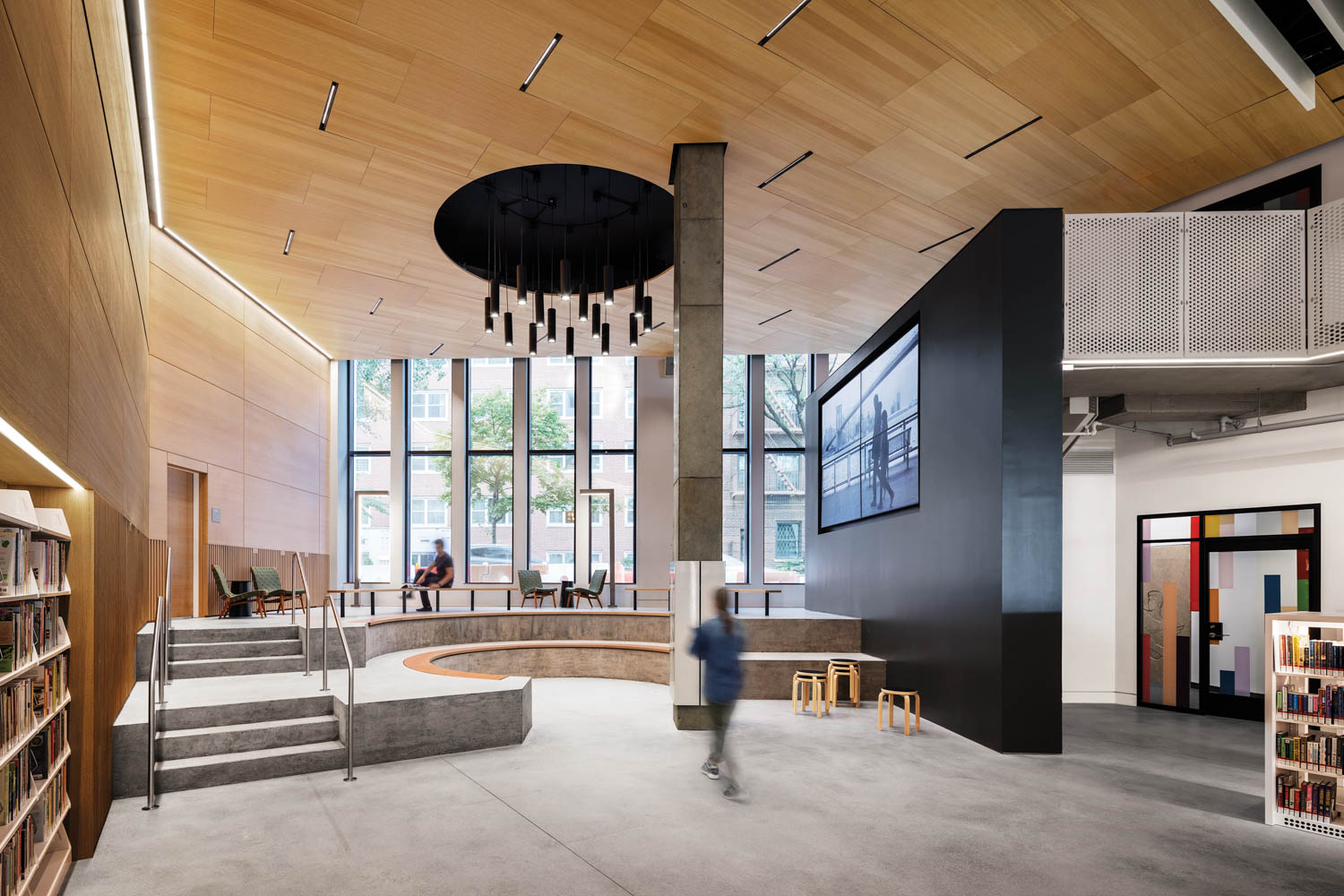 natural light flows in through windowed walls in the Brooklyn Heights Library