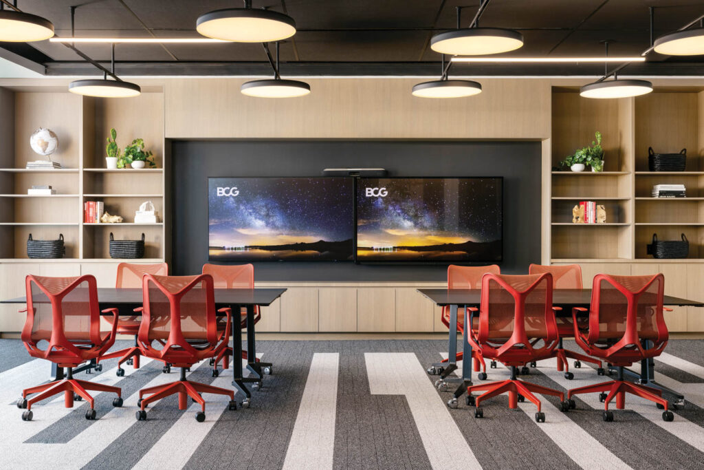 a digital meeting room with red office chairs at Boston Consulting Group