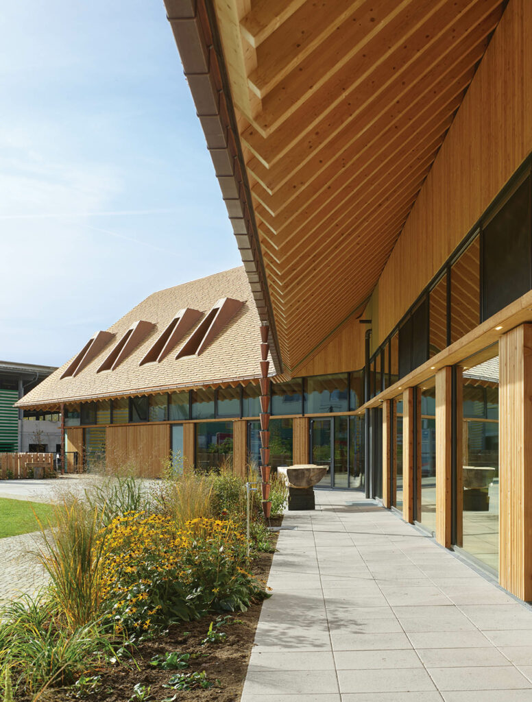 a building's wide roof overhang serves as sculptural rainwater downpipes