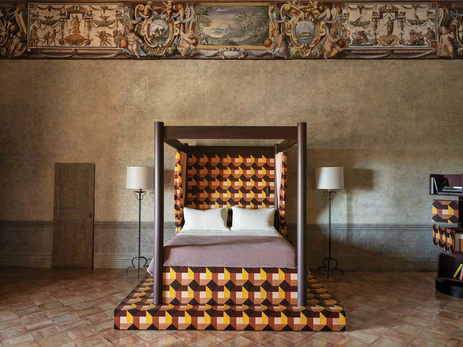 a graphic geometric print clothes the base and headboard of a bed in Rome's French Academy