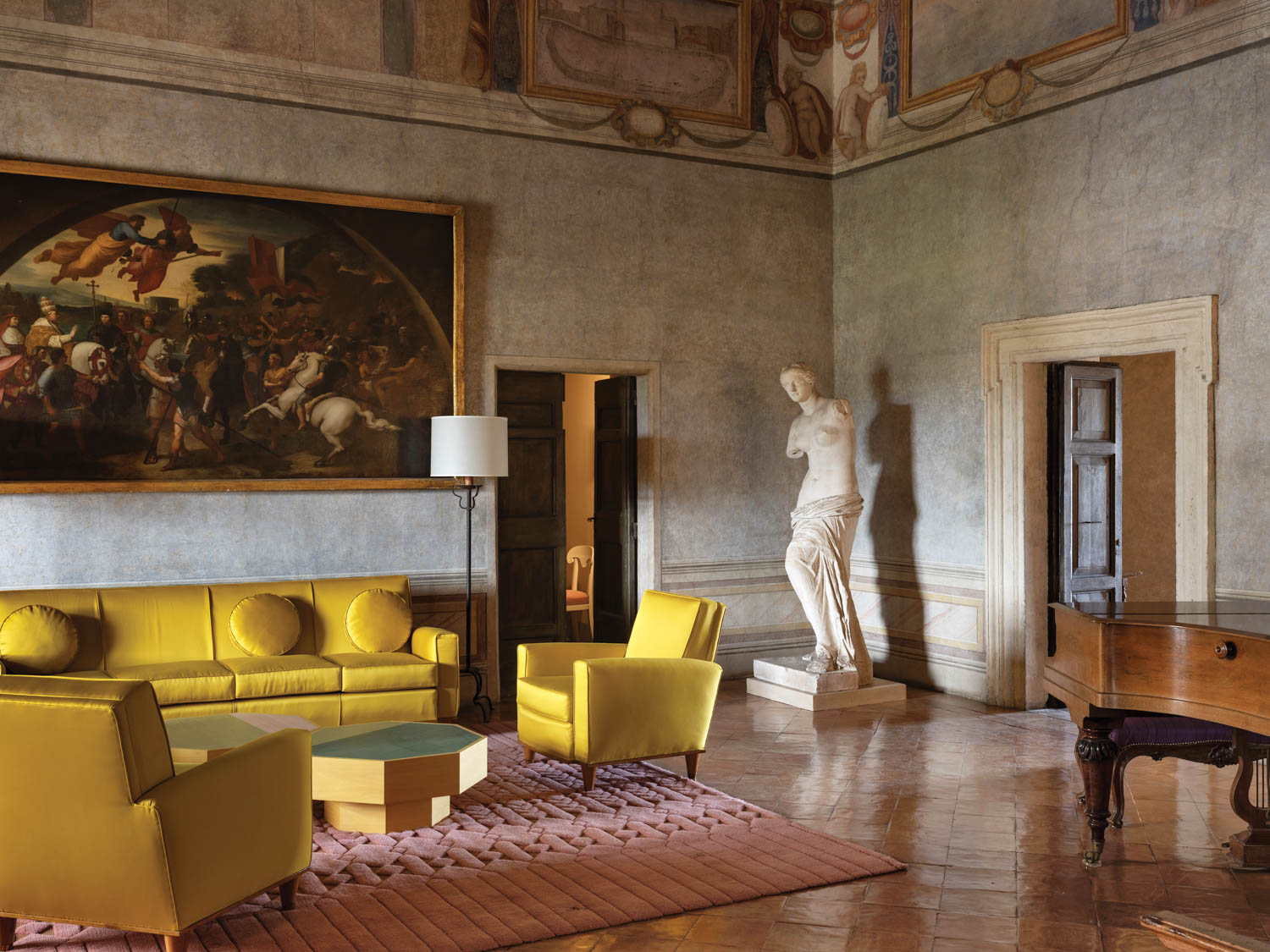 a Greco-Roman bust of a woman sits in the Renaissance-like room in the French Academy