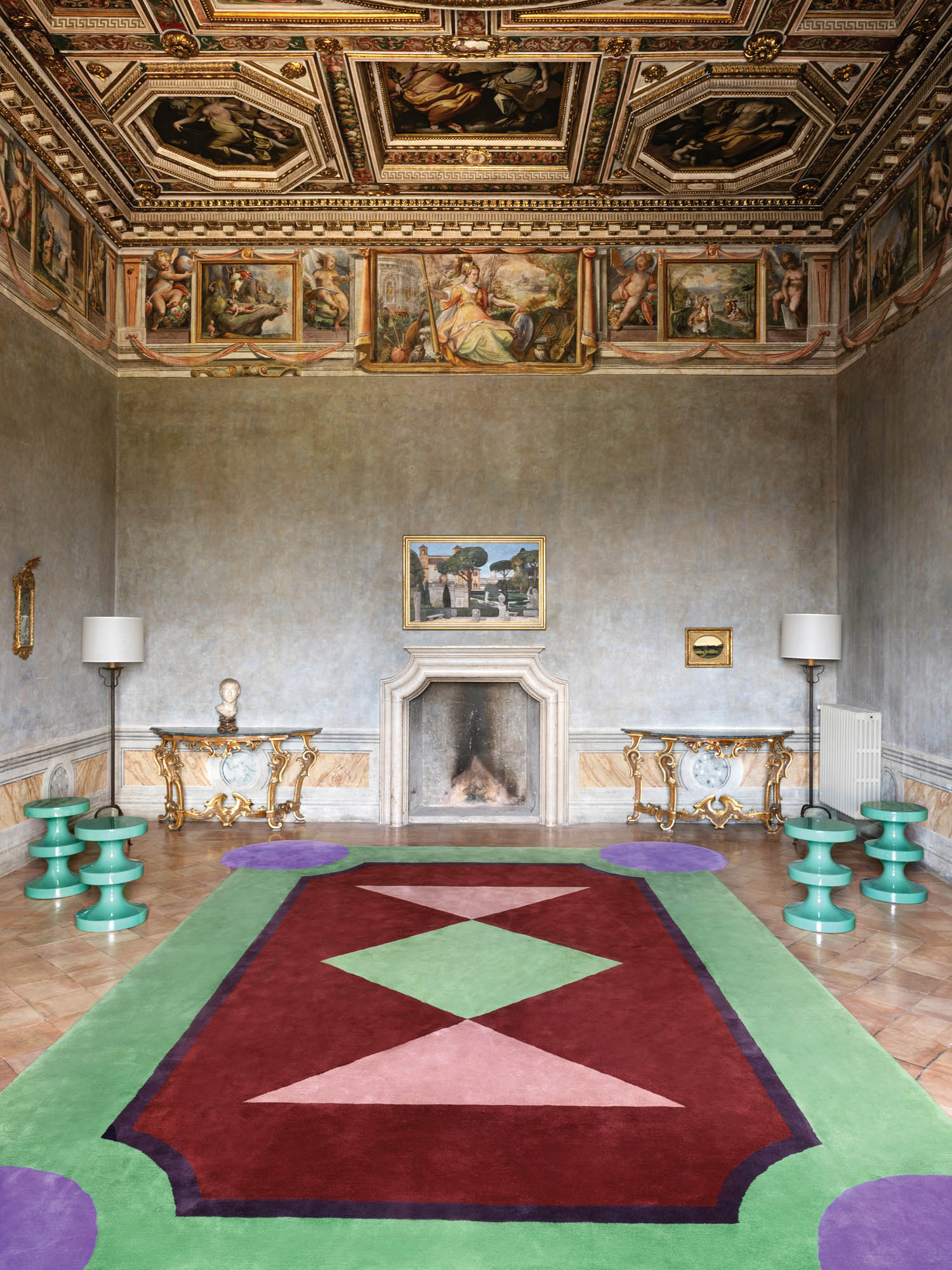 a colorful rug sits under a luxurious painted ceiling in Rome's French Academy