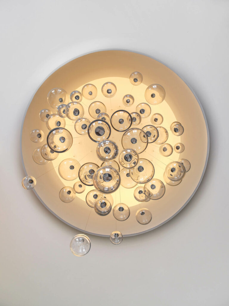 a custom pendant in a living room made of glass globes