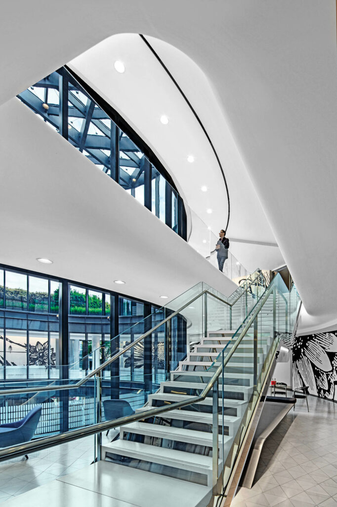 stairs rise through the atrium of Milbank in London