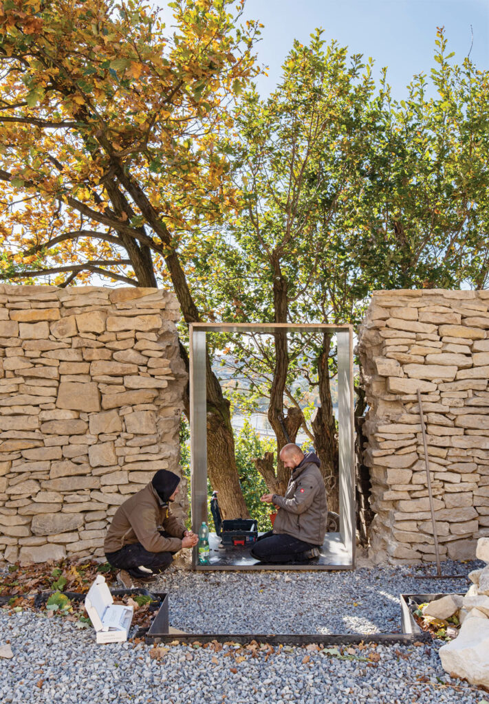 welders forming a steel-framed doorway to a winery