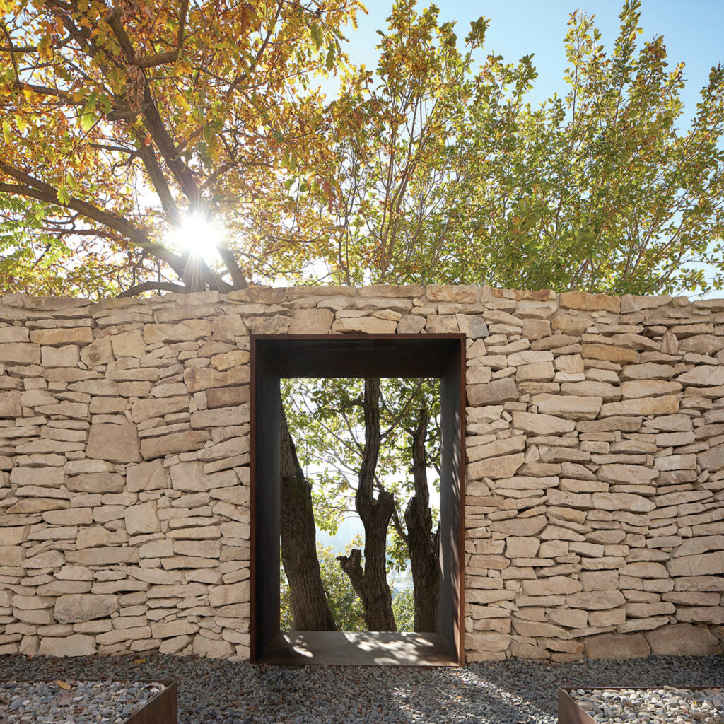 ancient oak trees are seen through the doorway at this Prague winery