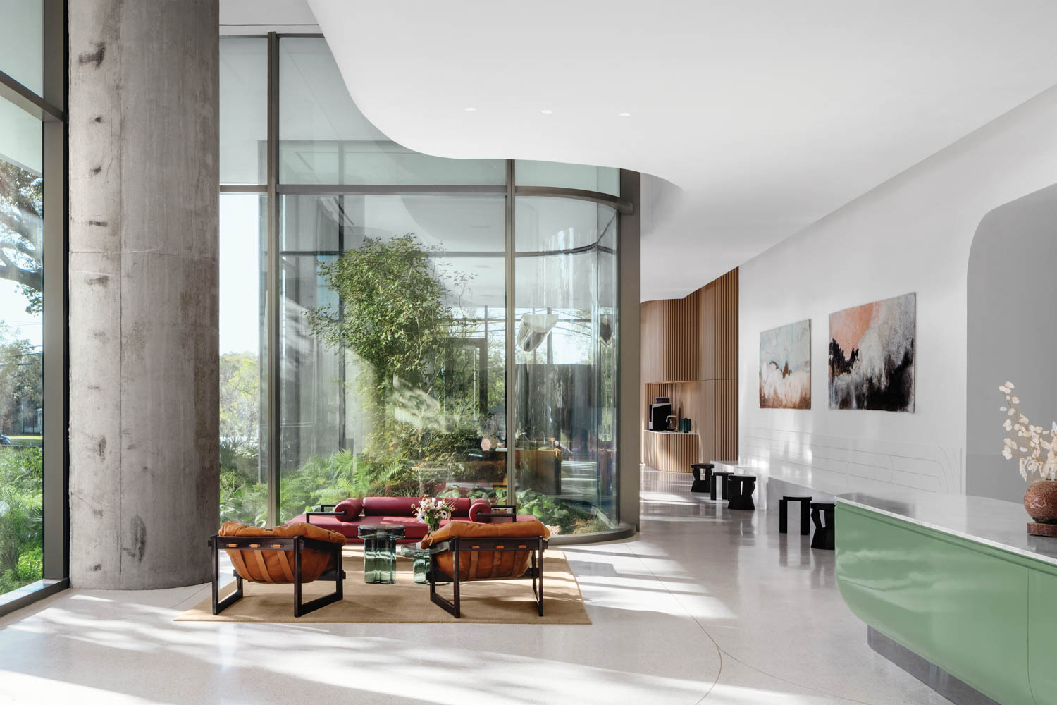 a greenhouse atrium curves into the wall of a residential lobby