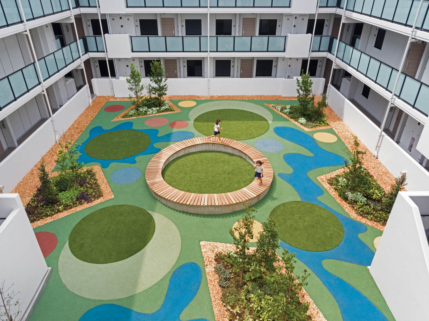 a turf with colorful geometric shapes in a courtyard at a Japanese residential building