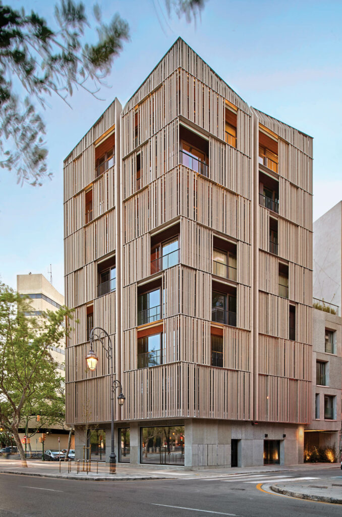 the exterior of an apartment building wrapped in Spanish pine