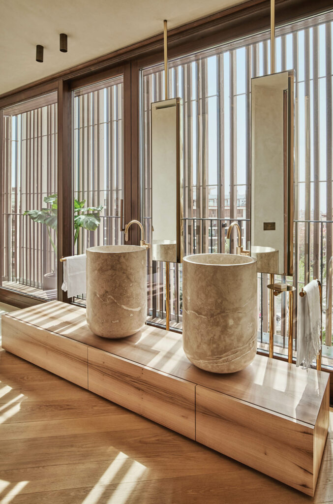 a bathroom inside a penthouse apartment clad in oak and natural materials