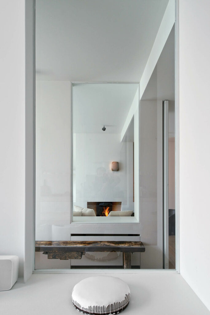 an interior window offers views through the kitchen into a corridor and the living room beyond