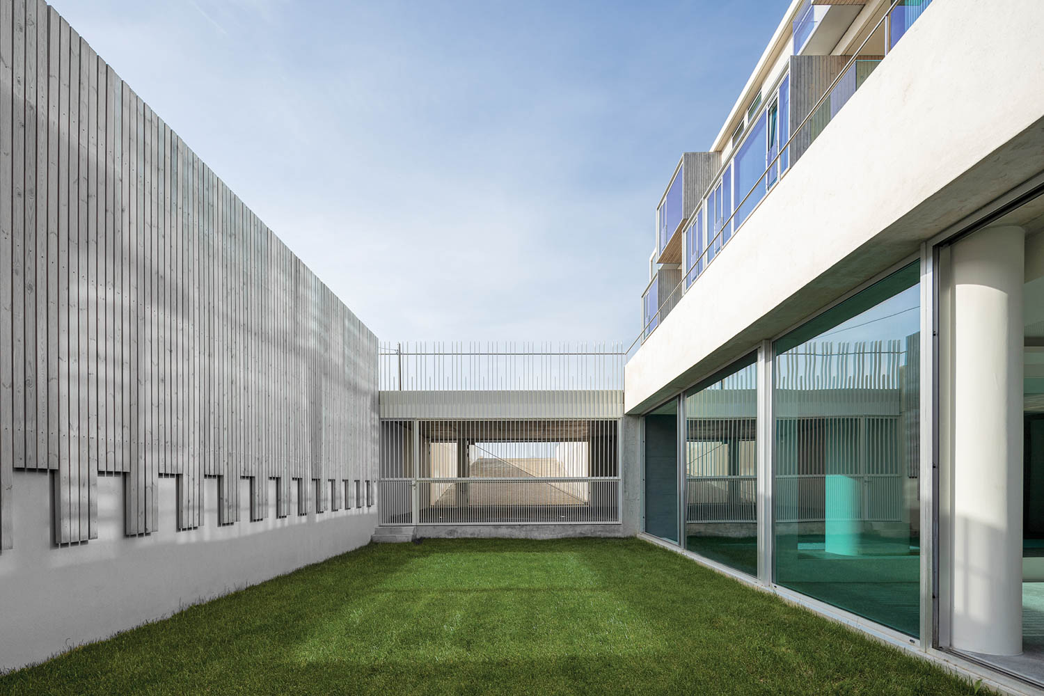 an indoor pool segues to an outdoor lawn at this apartment building