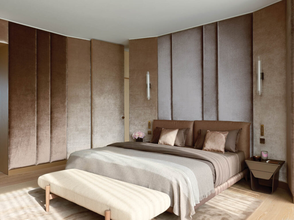 three shades of beige velvet upholster the walls of the main bedroom in this Budapest apartment