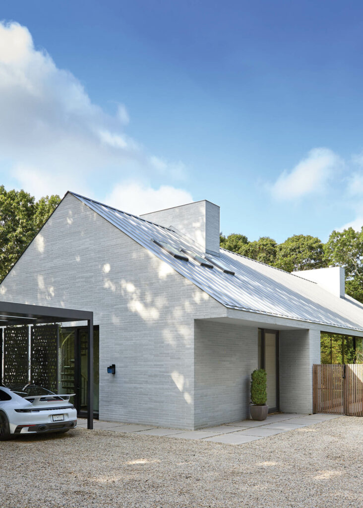 the exterior of a home designed by Sawyer|Benson that is built of recycled-glass brick