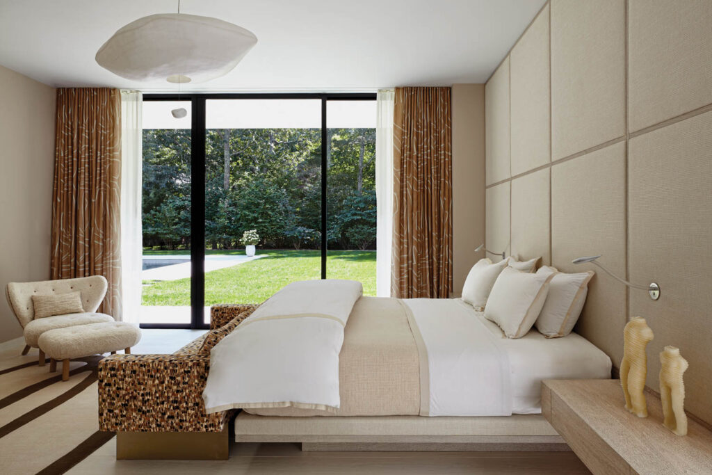 Dune's Stellar chair and ottoman face the bed in the primary bedroom