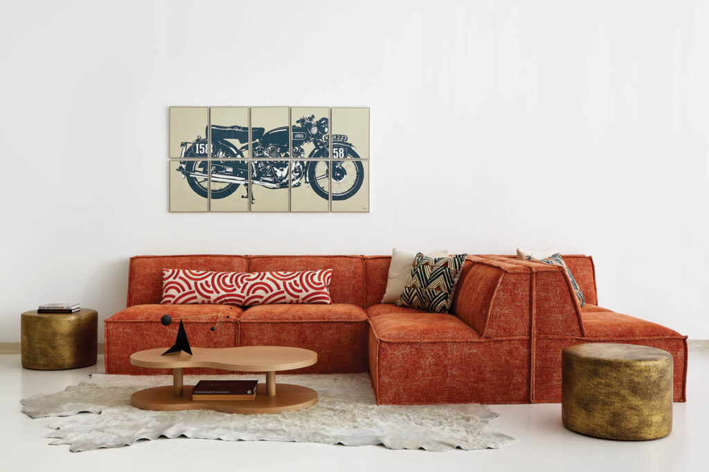 a cowhide rug in front of a red sofa in a lounge area of this home