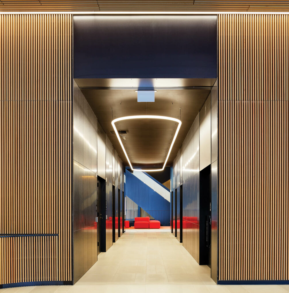 an illuminated elevator bank inside a Boston University building