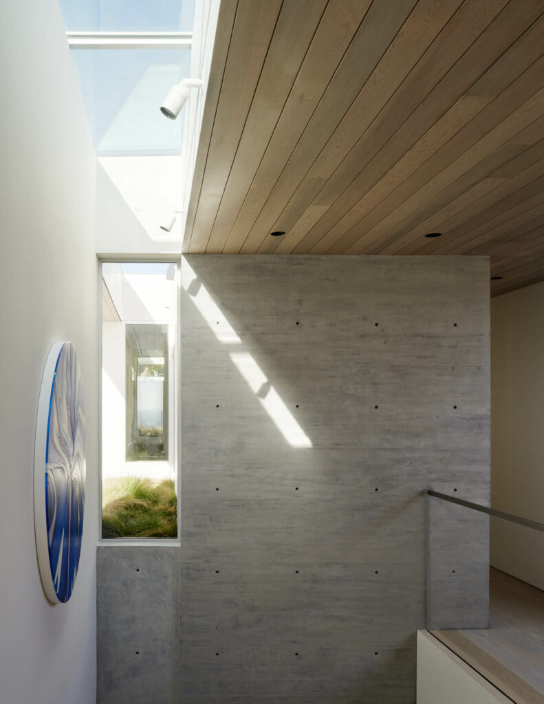 an open stairwell of a home with concrete end wall with a cut out slot