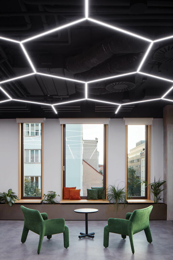 a workplace's café with hexagonal LED strips across the ceiling