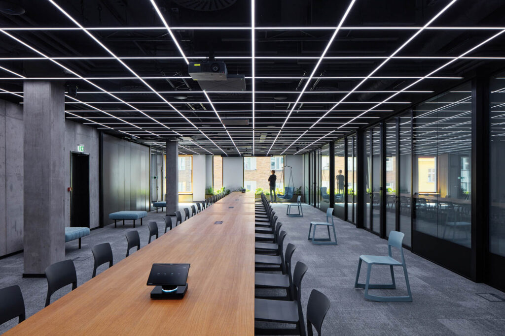 a long conference room table lined with chairs in Pricefx