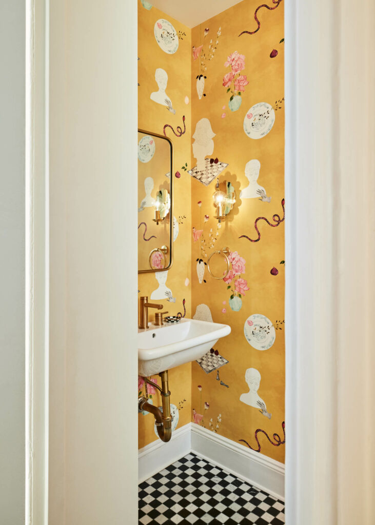 whimsical illustrated wallpaper cloaks the guest bathroom with a black and white checkered floor