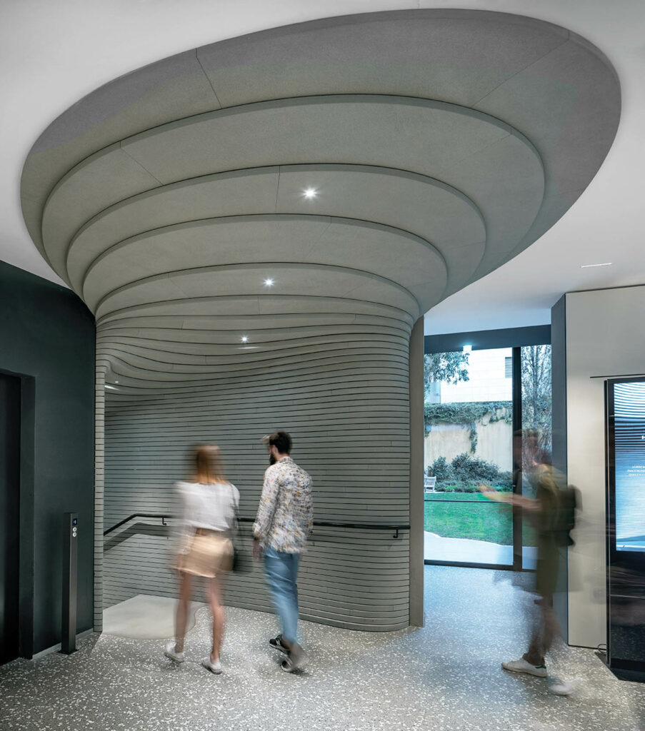 A stairway leading to exhibition spaces below in a Milanese museum