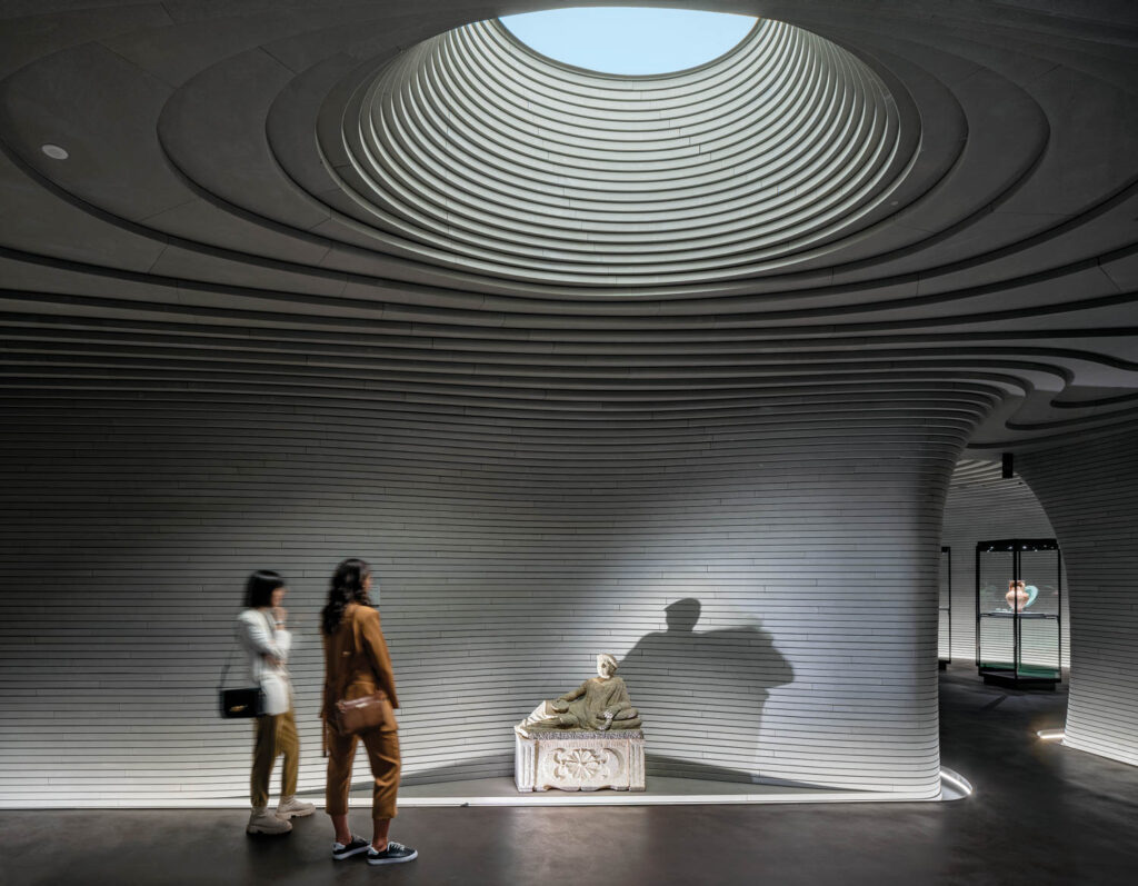 small openings in the limestone panels at a Milanese museum