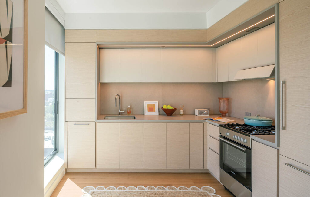 an apartment kitchen with a heavily neutral palette