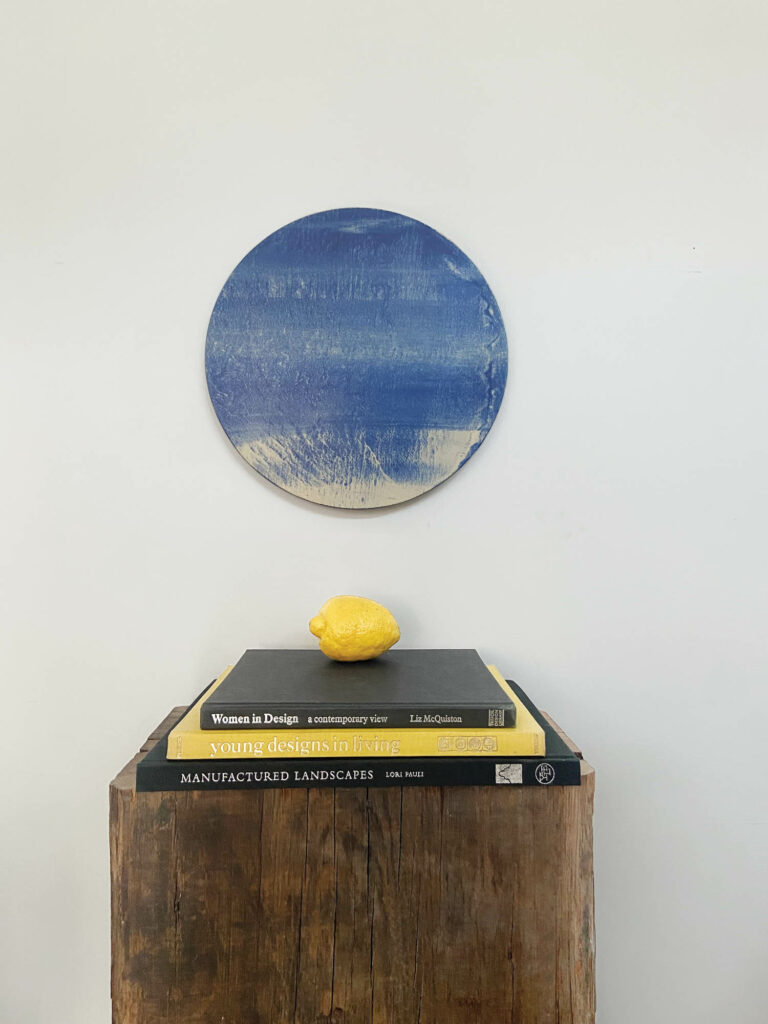 Olivia Barry's tinted porcelain Blue Moon Tondo, with a 13-inch diameter, 4-mm thickness, and wiring to be backlit