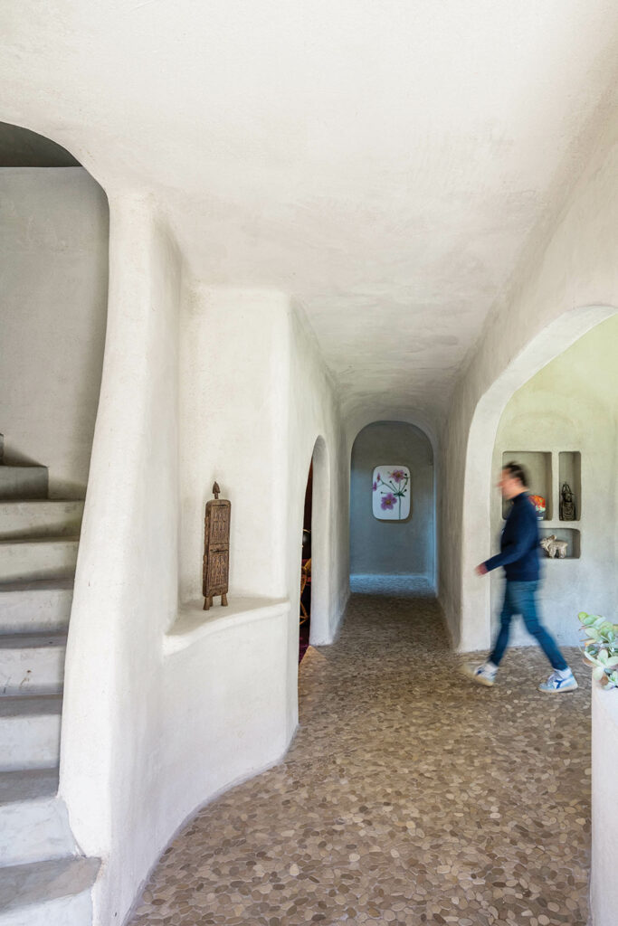 a staircase leads to the library inside the entrance to this home