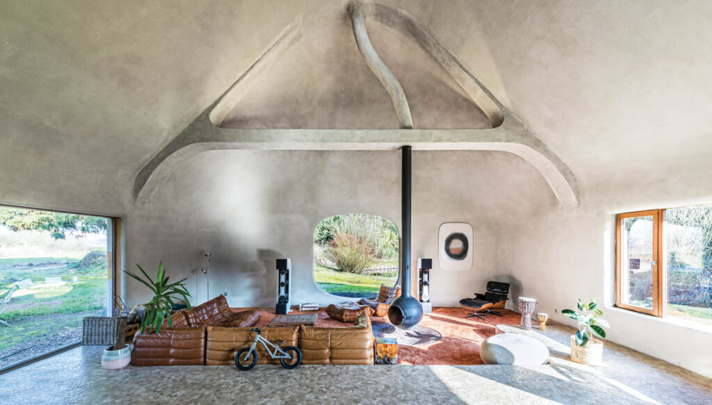 vintage furniture in the conversation pit of a home made from a renovated barn