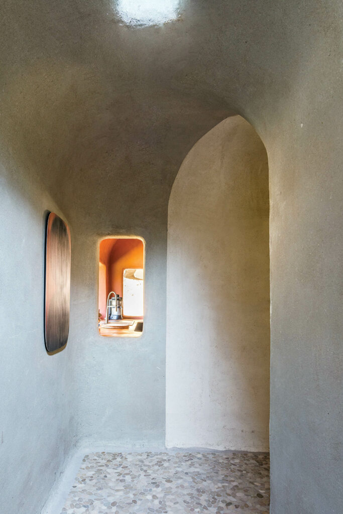 A cutout peeking into the kitchen of a Belgian home