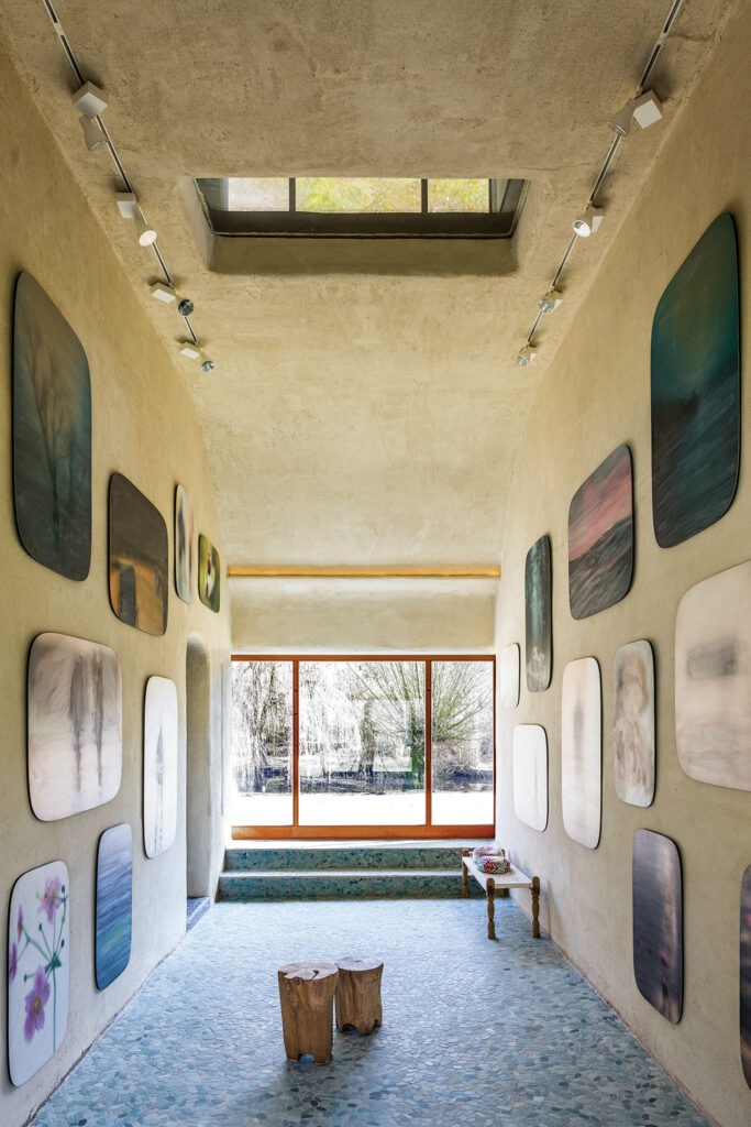 tree sections serve as stools in the gallery area of a Belgian home