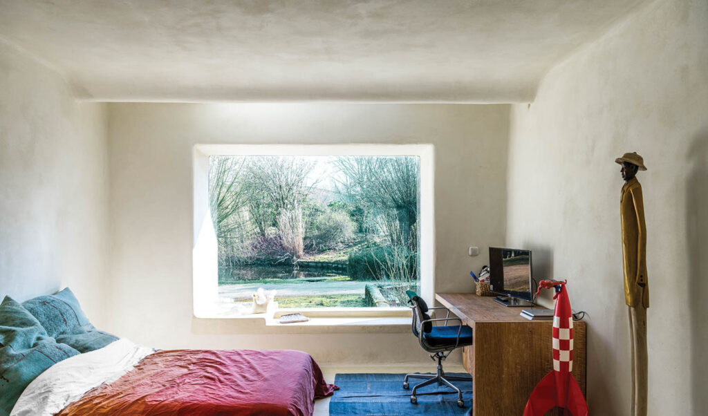 a bedroom with sunlight filtering into the window