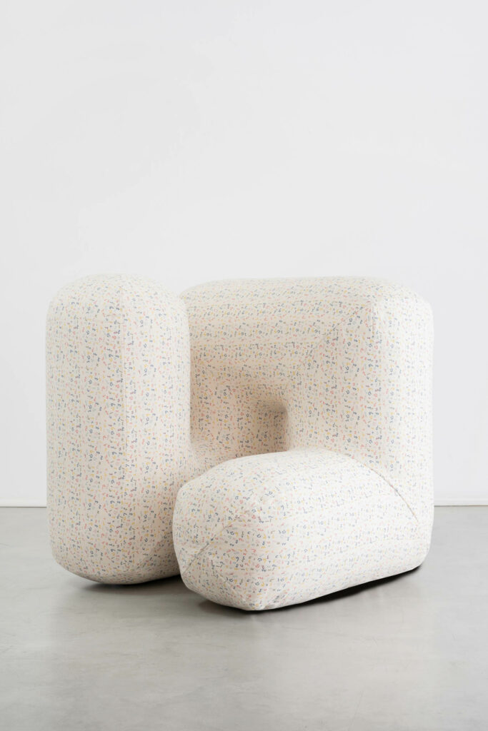 A cream chair in a geometric form