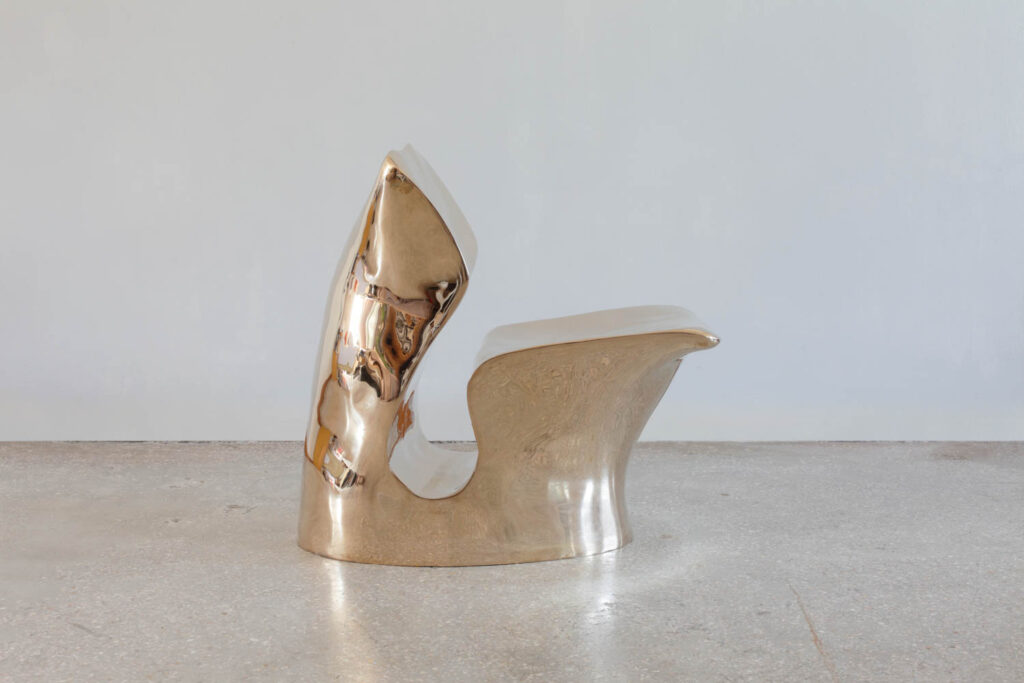 A bronze chair with an abstract shape