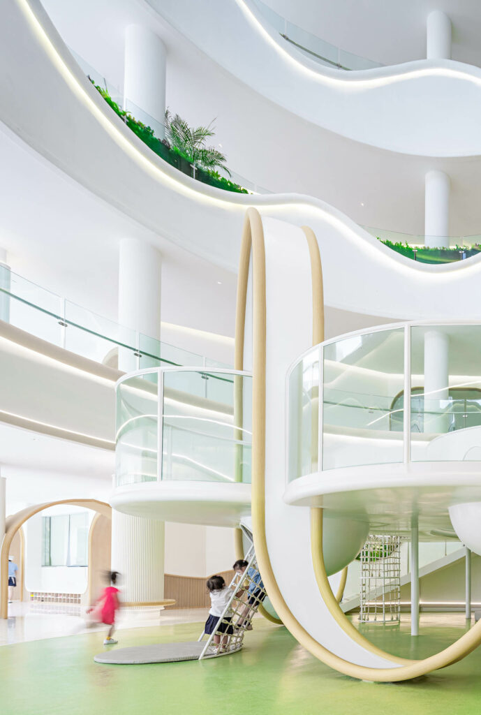 A multi-level play area in shades of white and green