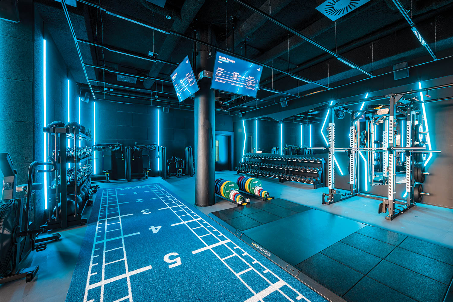 A gym area with dark blue flooring