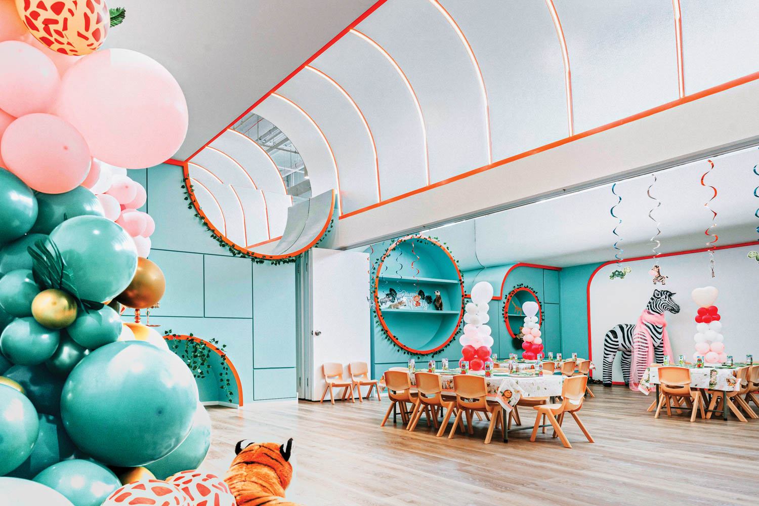 A dining room in orange and teal in Funzy Play Family Club