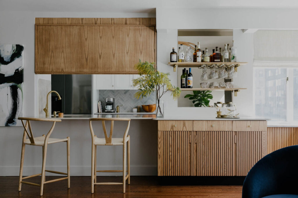 A breakfast nook with a small kitchenette and wooden bar counter