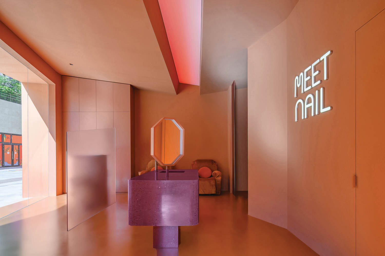 A room with orange walls and a purple console