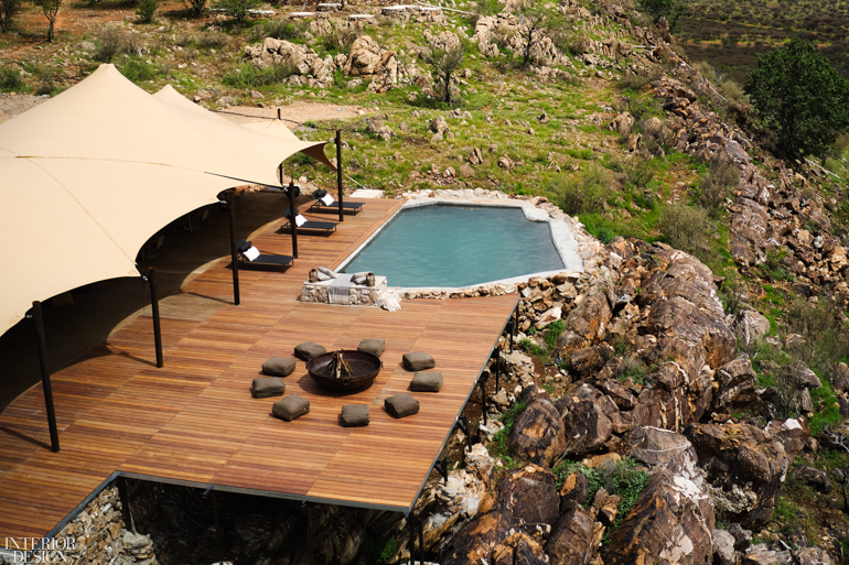 A pool on a cliff surrounded by the natural landscape