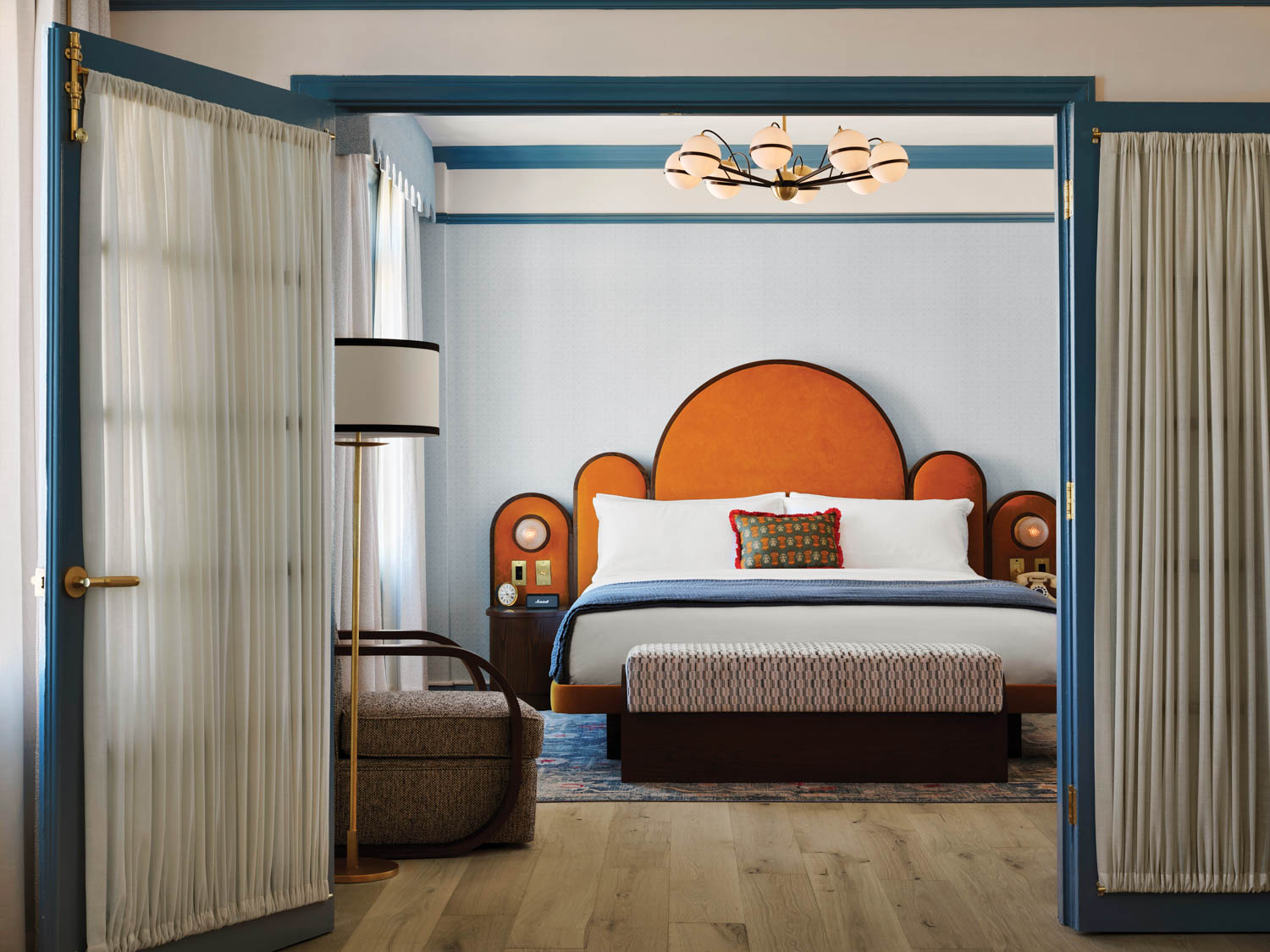 a curved headboard in a guest room at the Georgian