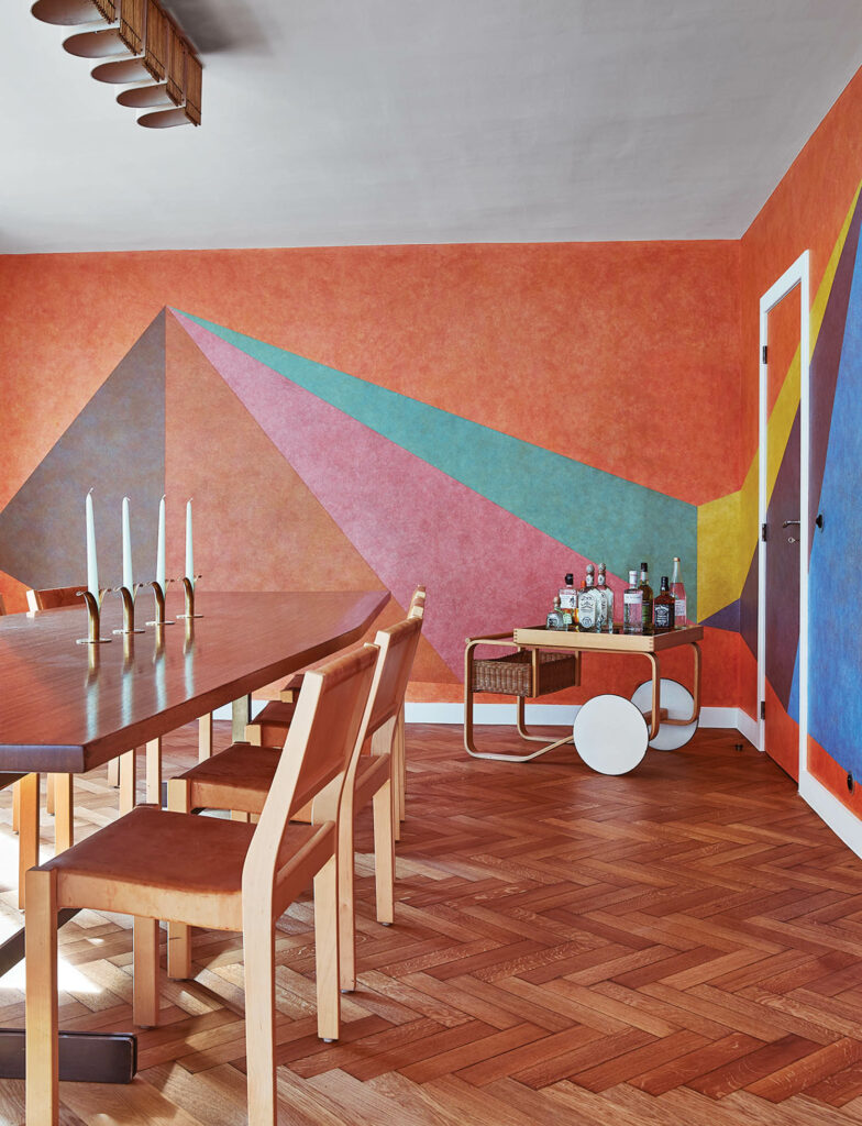 colorful, conceptual artwork on the wall of a dining room