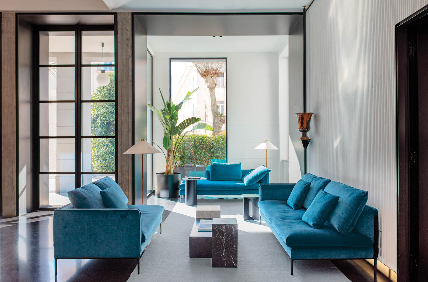 blue sofas in a sitting area of a guest room at a hotel