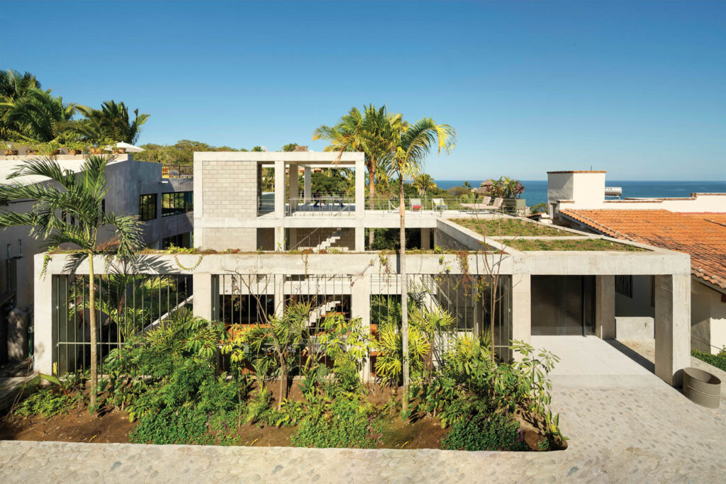 the exterior of a boutique hotel in Mexico with unfinished-concrete linear cubes