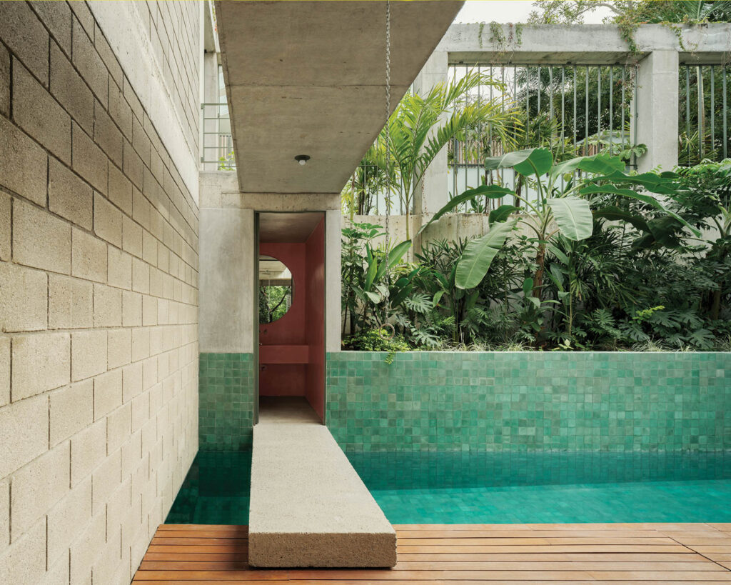 ceramic tiles line the lap pool at this hotel/villa